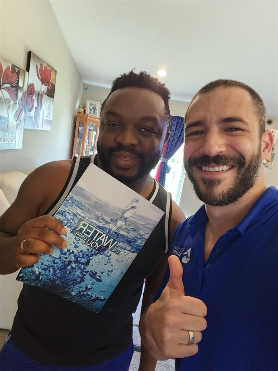 Pure Home Wellness customer reviewing water education booklet